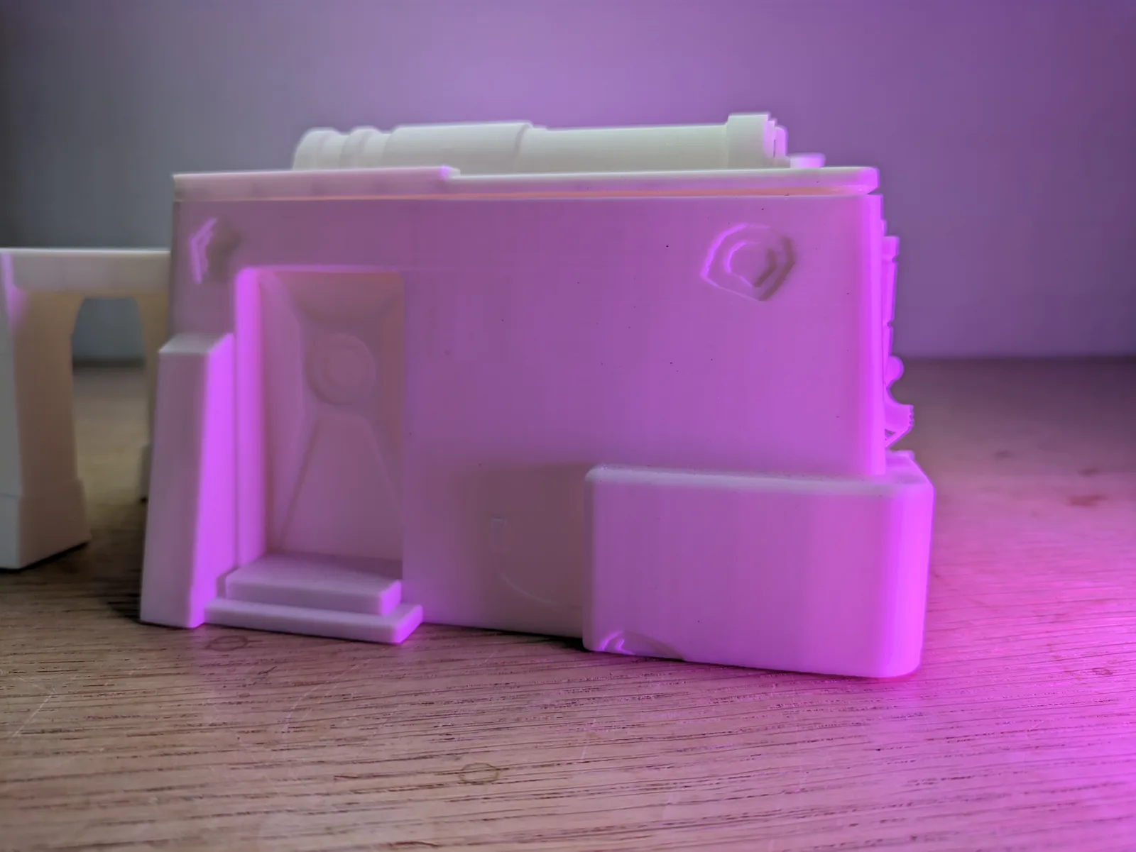 White PLA Imperial Terrain wall section freshly printed on a Bambu Lab P1P, surface detail visible before primer