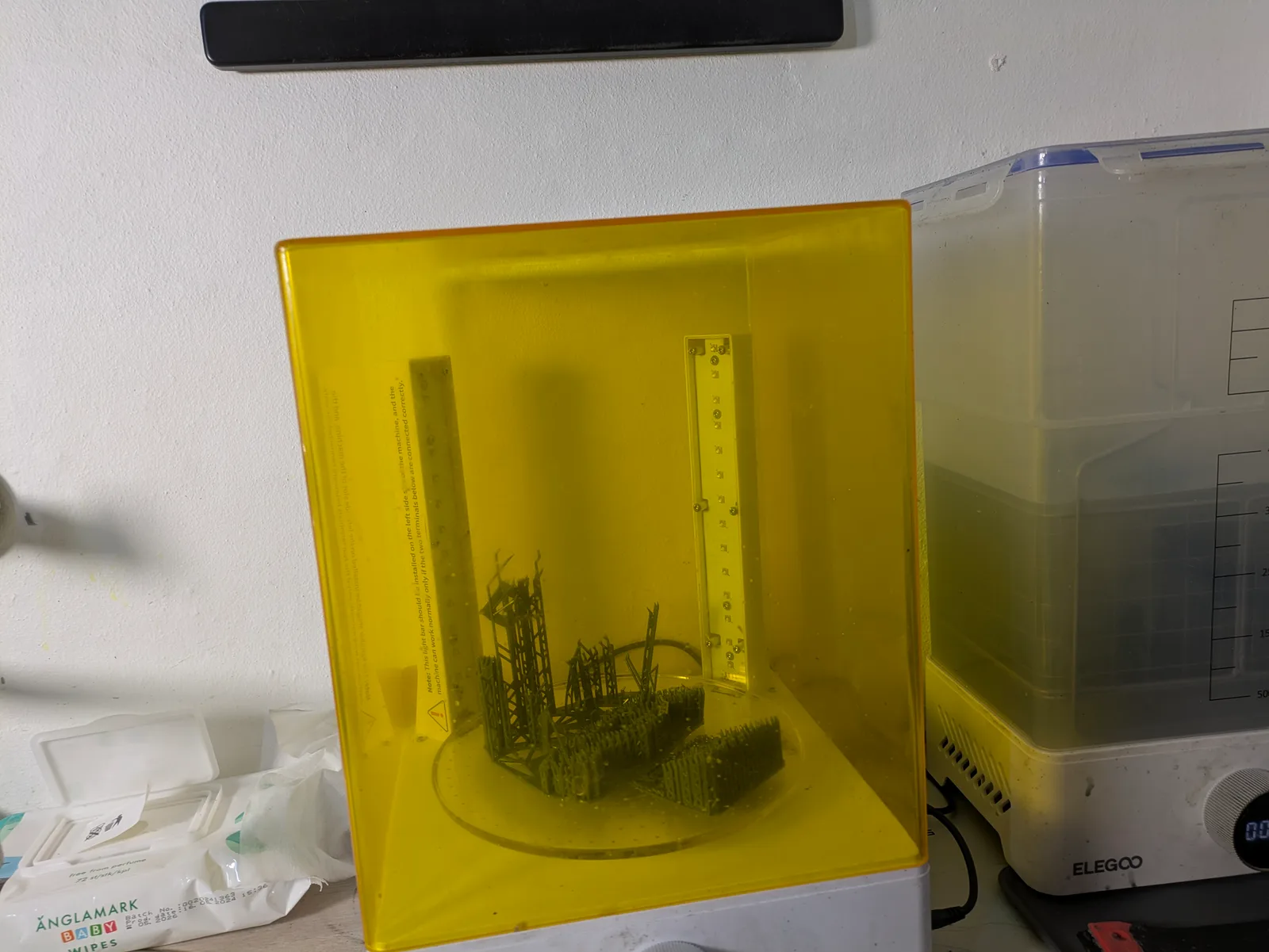 Elegoo Mercury Plus wash and cure station with a print on the turntable under UV cure, workbench context