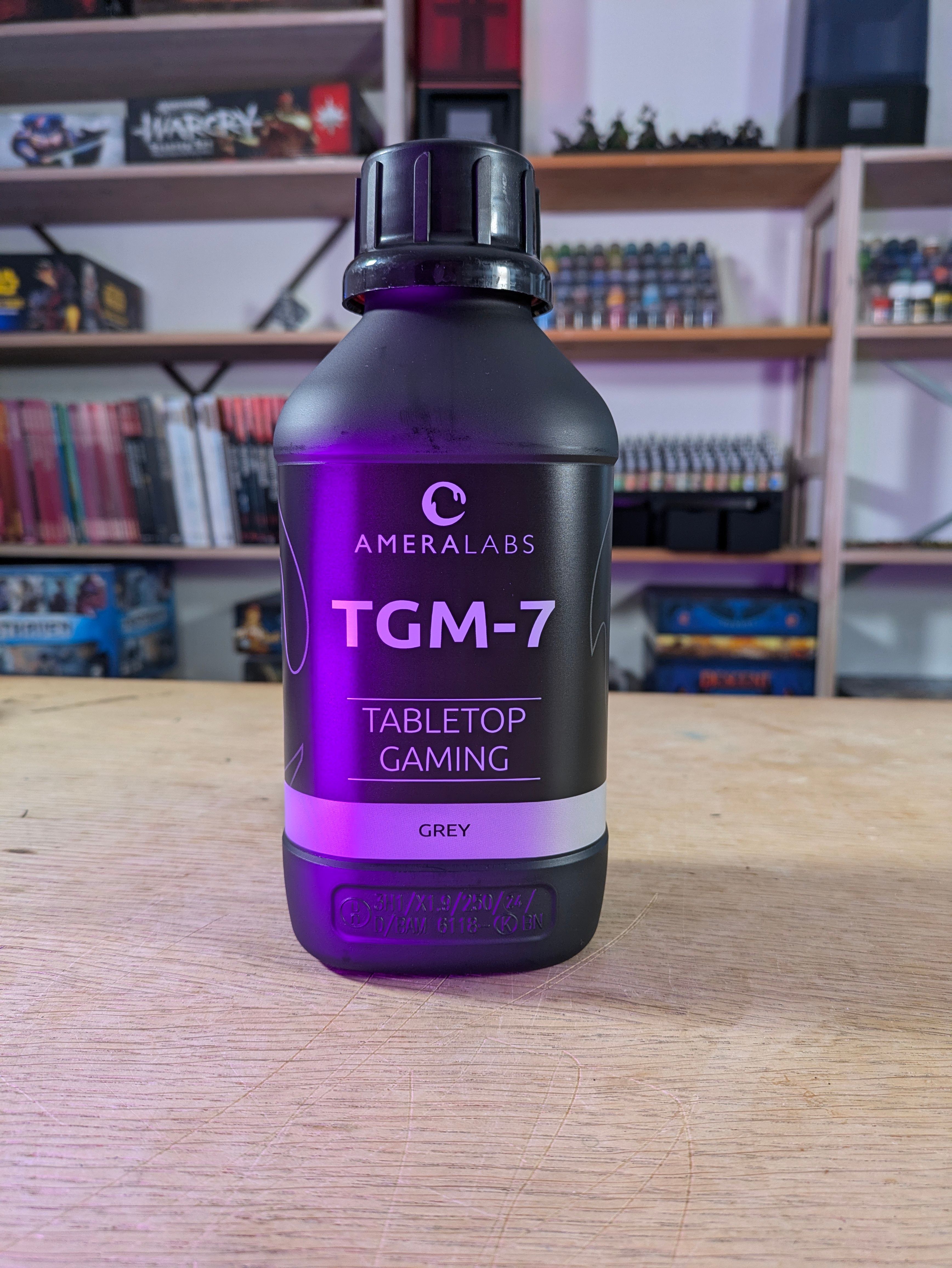 AmeraLabs TGM 7 Grey close up showing the black bottle with purple accent and the TGM 7 Tabletop Gaming Grey label